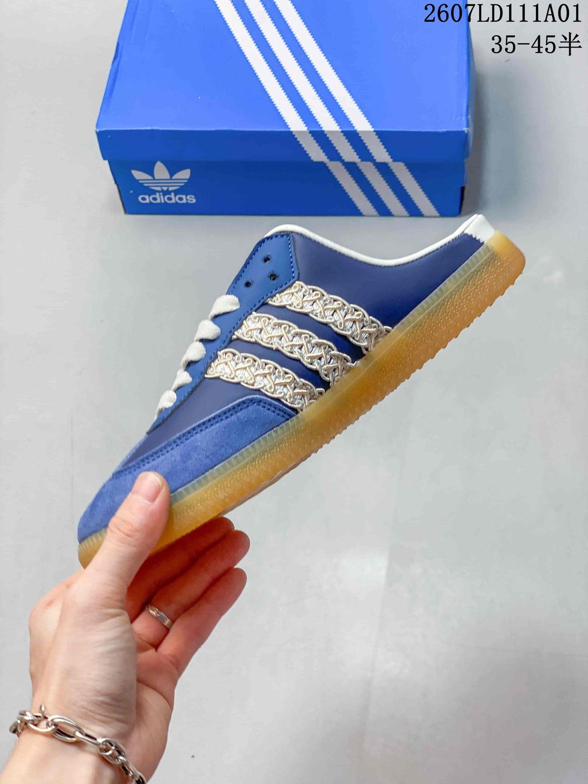 Side profile of the blue mule shoe with decorative chain-style stripes