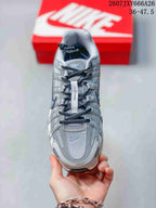 Top view of a gray and white Nike P-6000 sneaker showing the mesh toe area, layered upper panels, laces, and padded tongue.