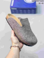 Close-up of a gray closed-toe clog showing the textured upper, footbed area, and dark outsole.