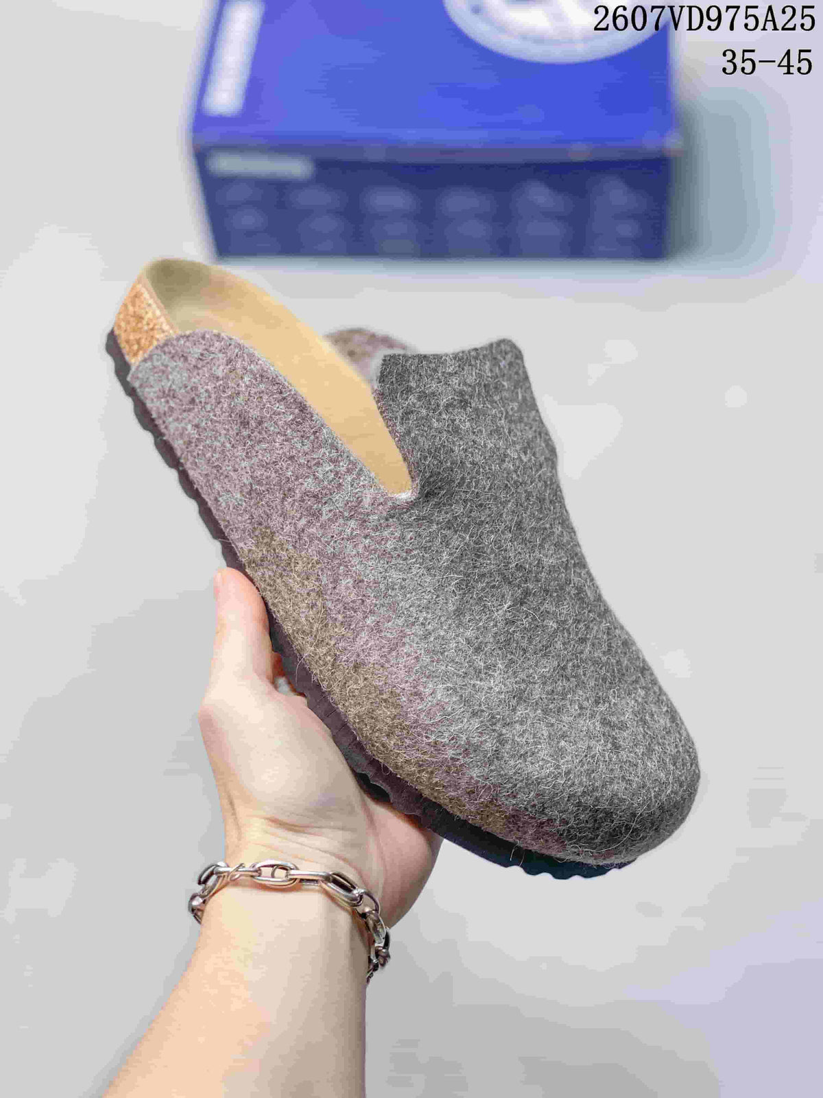 Close-up of a gray closed-toe clog showing the textured upper, footbed area, and dark outsole.