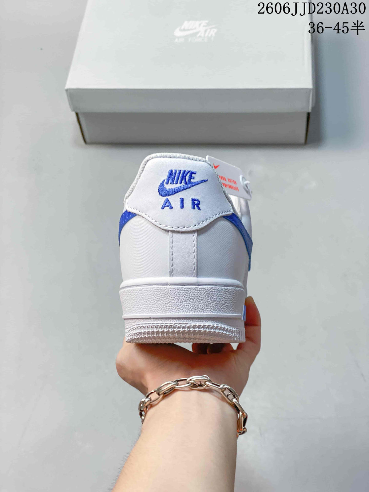 Rear view of a white sneaker with blue heel accents