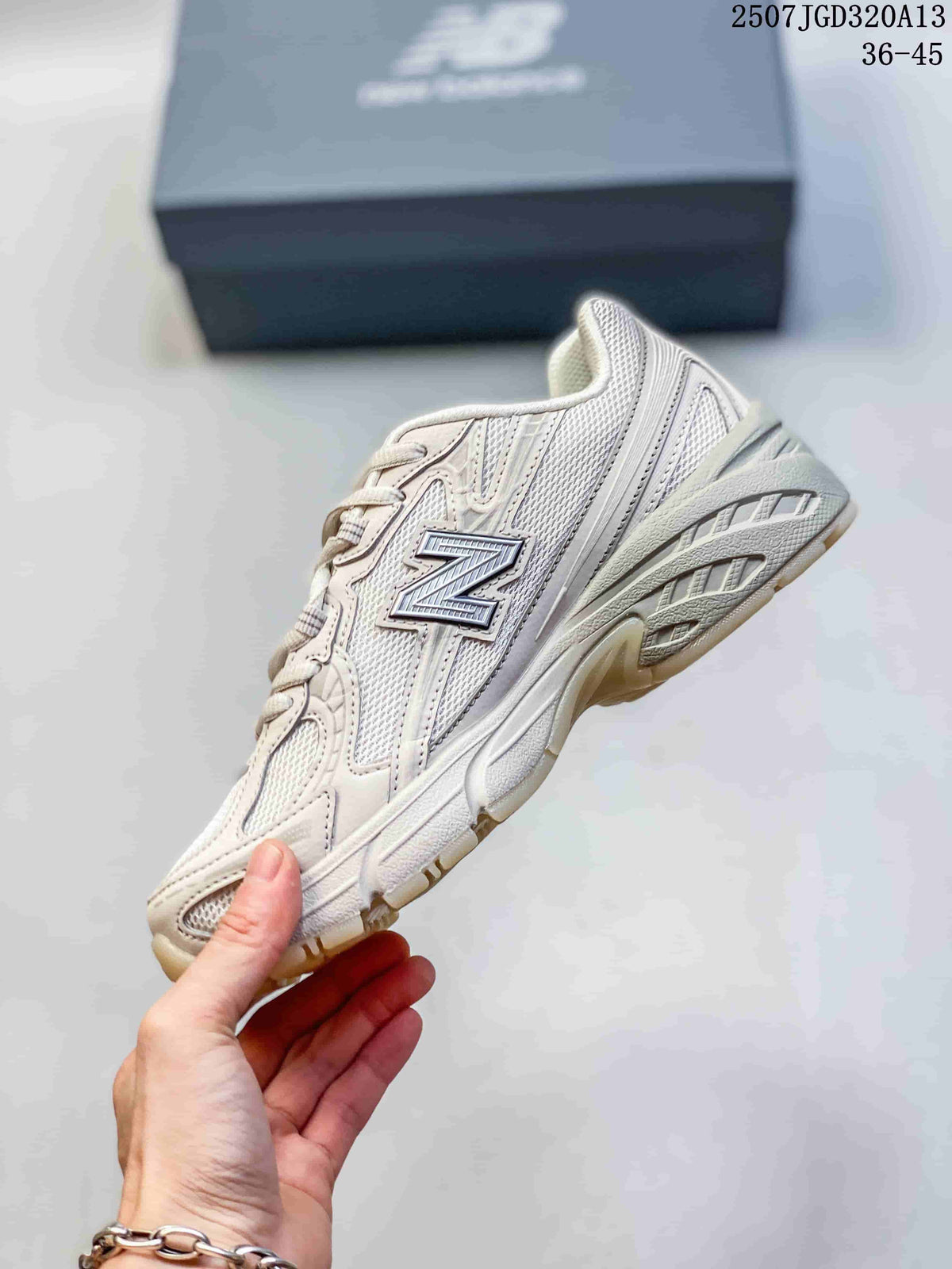 Side view of the cream New Balance 740 sneaker showing the large N logo, mesh panels and layered upper.