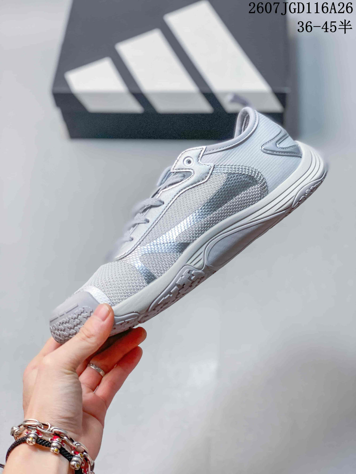 Side profile of a silver gray adidas sneaker showing layered panels and a low-profile sole