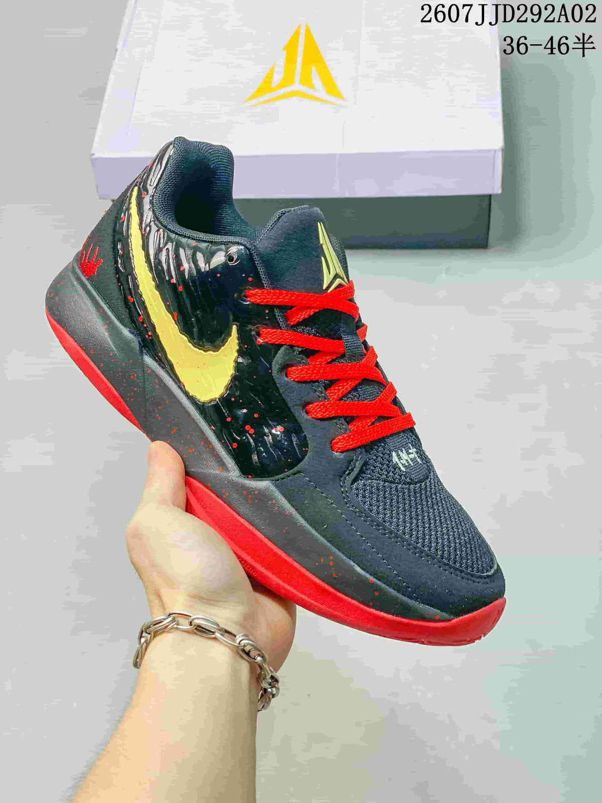 Black Nike JA 2 basketball shoe with red laces, a yellow Swoosh and a red outsole.