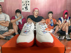 Front view of white and red Nike basketball shoes with lace-up uppers and perforated toe areas.