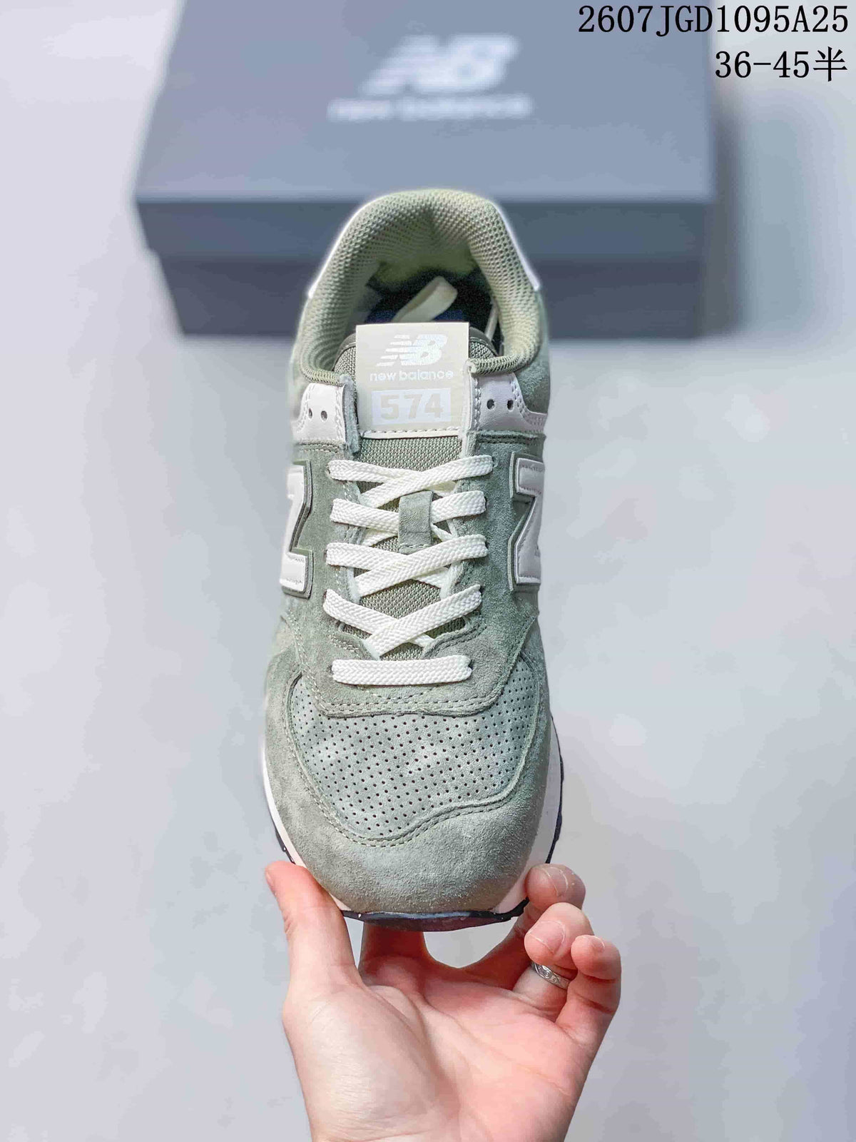 Front view showing the perforated toe panel, white laces and 574 tongue label.