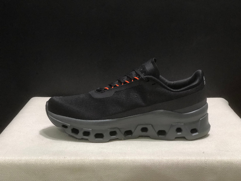 Side profile of a black Cloudmonster 1 sneaker showing its low-cut shape and sculpted sole.
