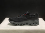 Side profile of a black Cloudmonster 1 sneaker showing its low-cut shape and sculpted sole.