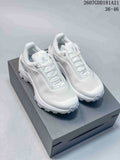 White KAILAS VENTO shoes displayed on a black shoe box, showing the low-top shape, padded collar and lugged outsole.