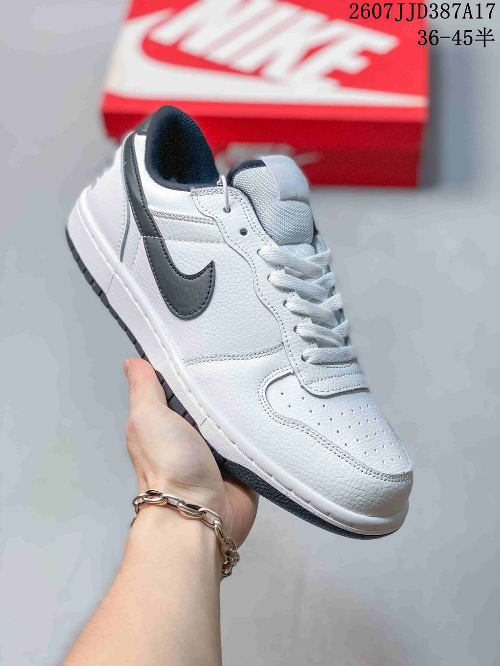 Angled side view showing the white upper, black Swoosh, padded collar and textured outsole.