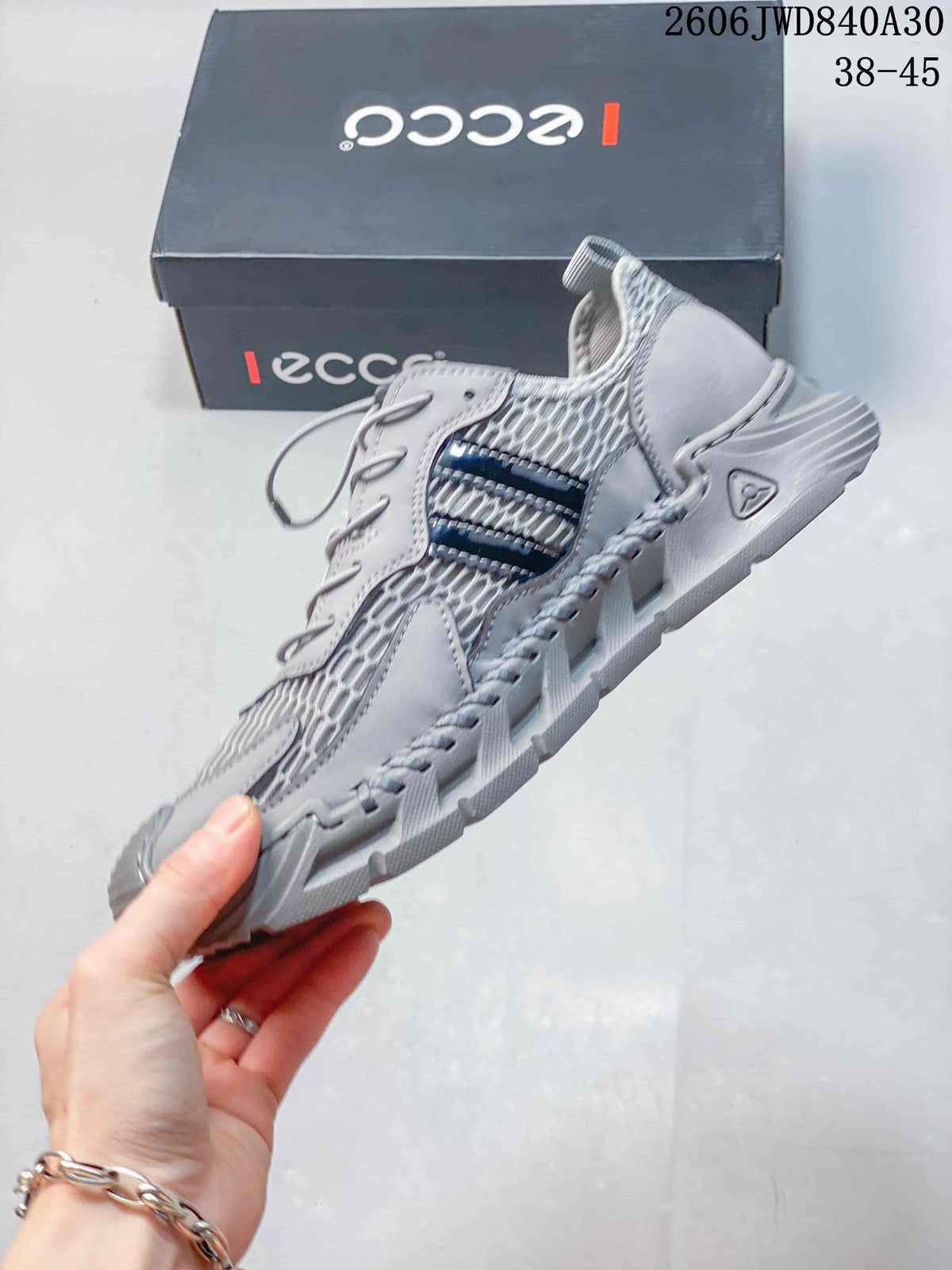 Side view of the gray mesh sneaker with dark side accents