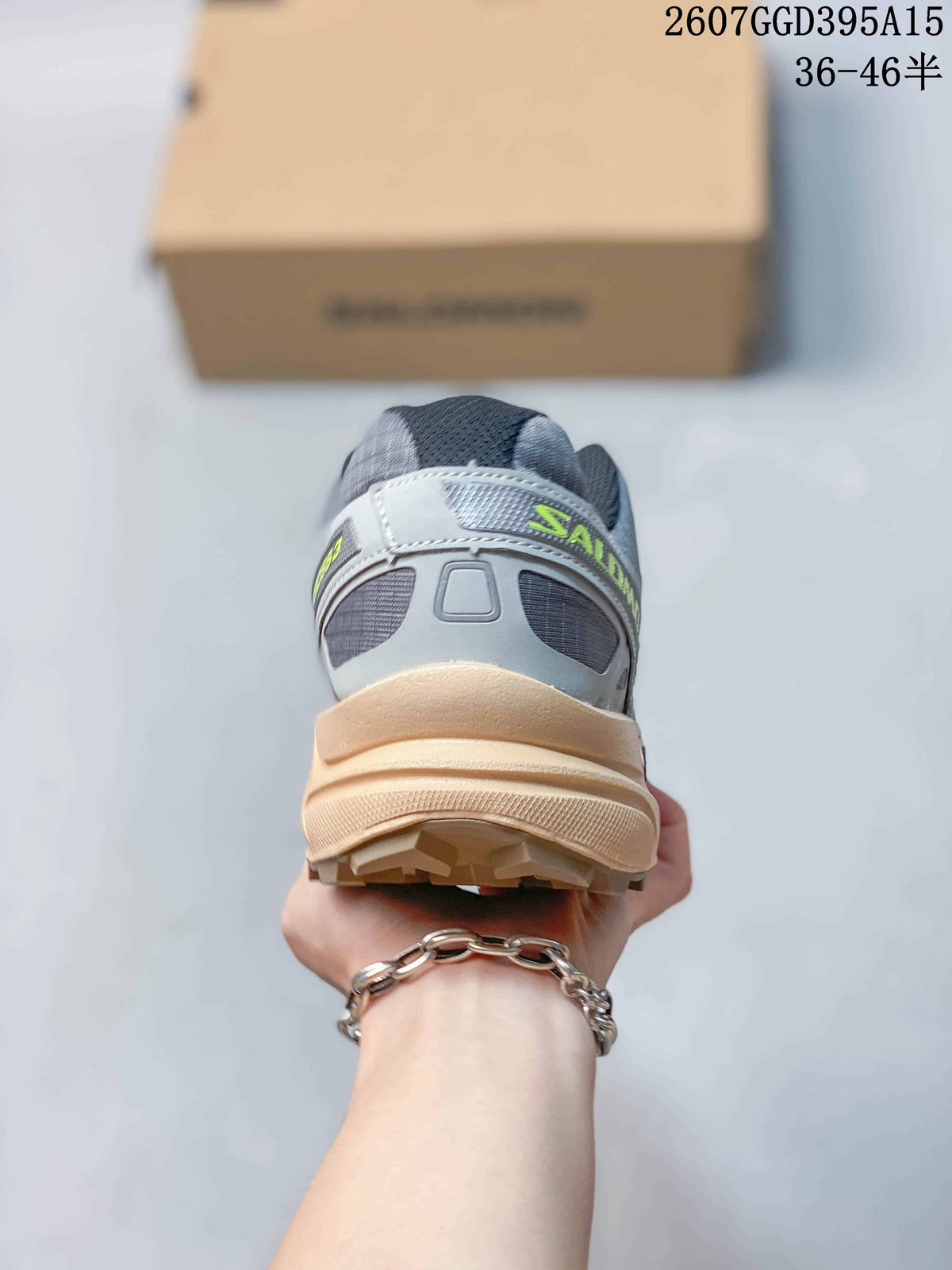 Rear view showing the padded heel, gray upper panels, lime detailing, and lugged outsole.