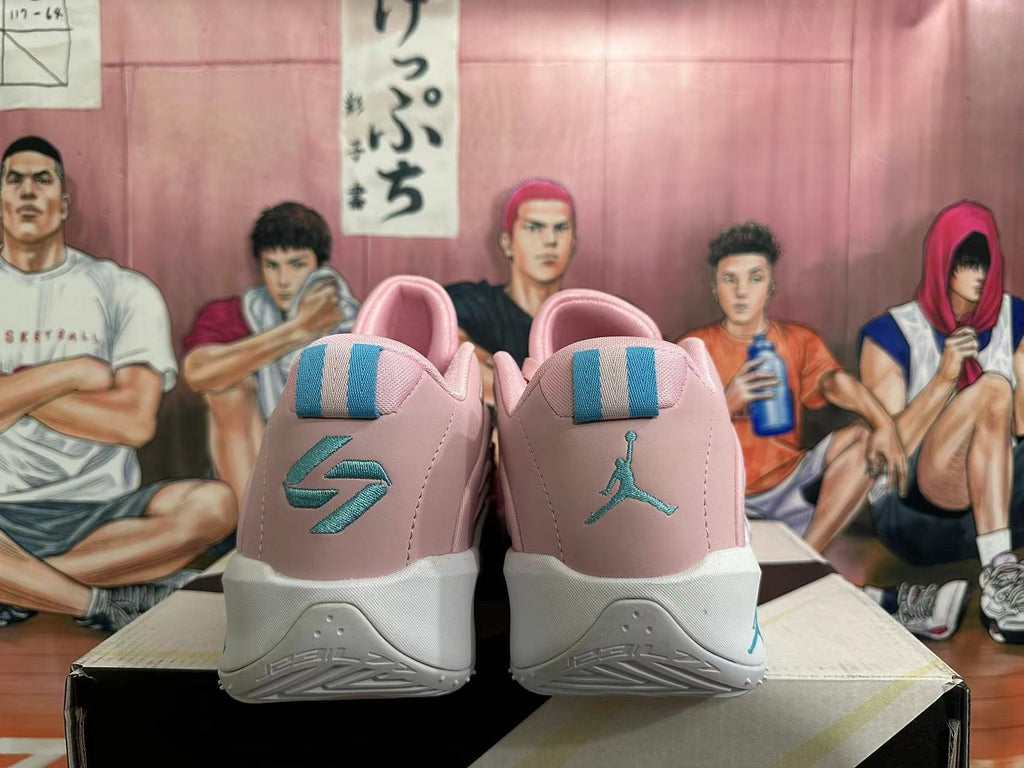 Rear view of pink and white basketball shoes with turquoise heel details