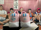 Rear view of pink and white basketball shoes with turquoise heel details