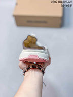 Rear view of the Salomon slip-on showing the white heel, layered sole and pink outsole accent.