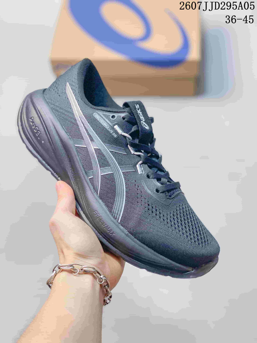 Dark gray ASICS running shoe with light reflective-style stripes and a dark outsole.