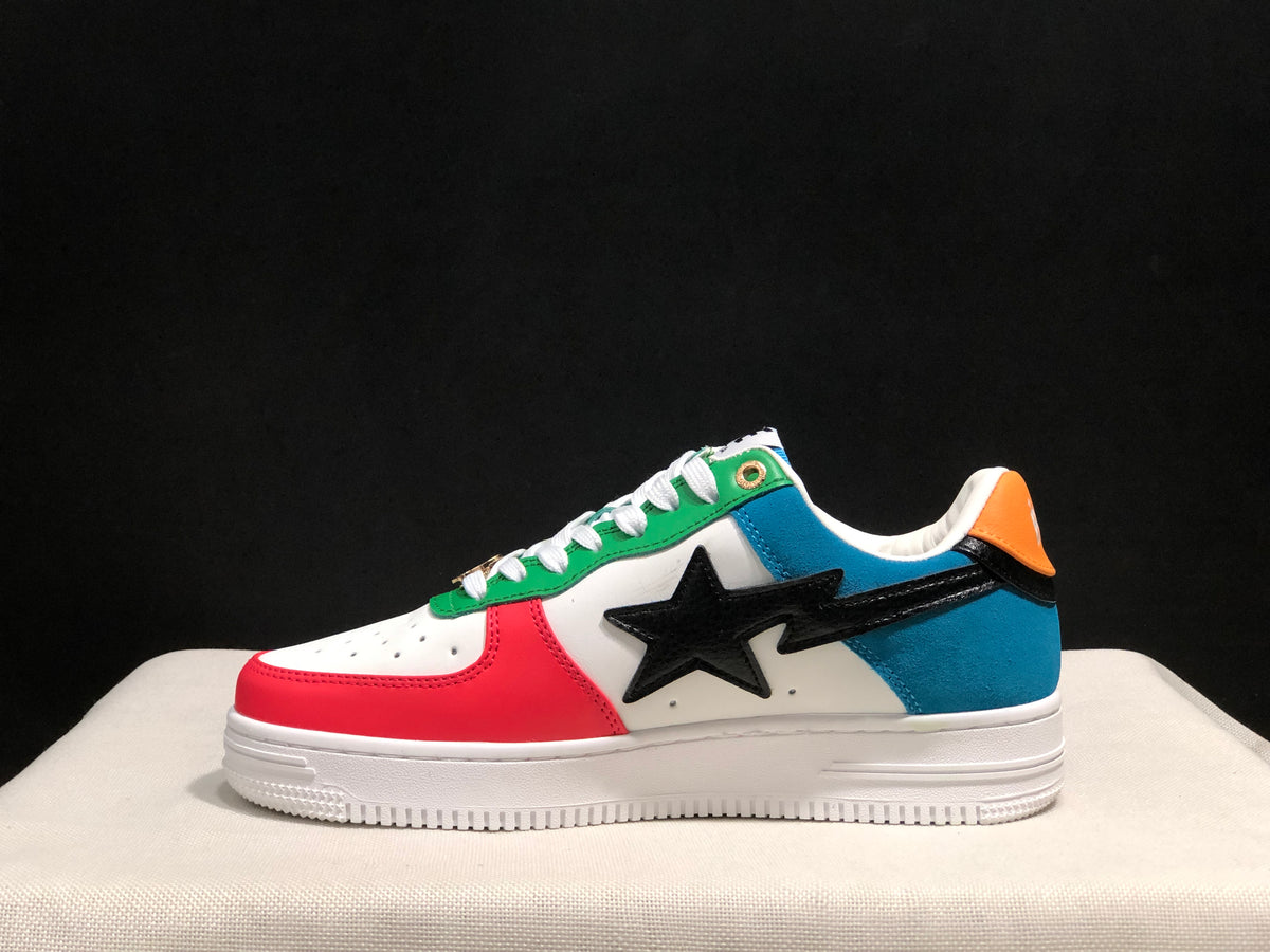 Side profile showing a red toe overlay, blue heel panel, green eyelet panel, and black star detail.