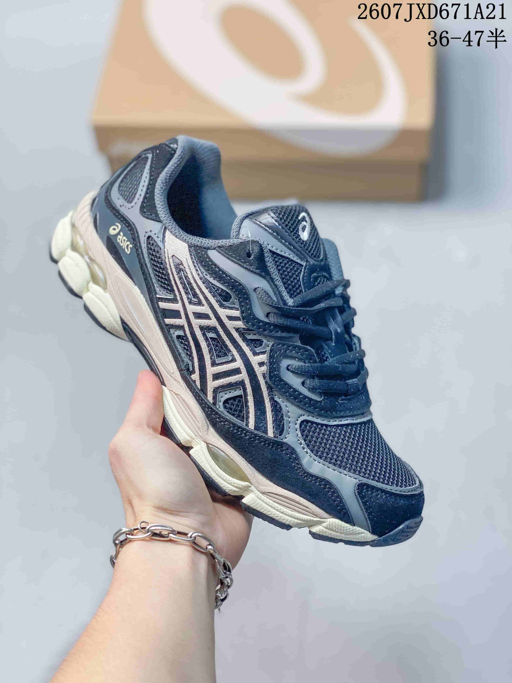 Navy and gray ASICS GEL-Kayano 14 sneaker with a contrasting light sole.