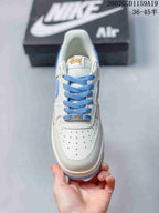 Top view showing the white perforated toe box, light blue laces and tongue branding.