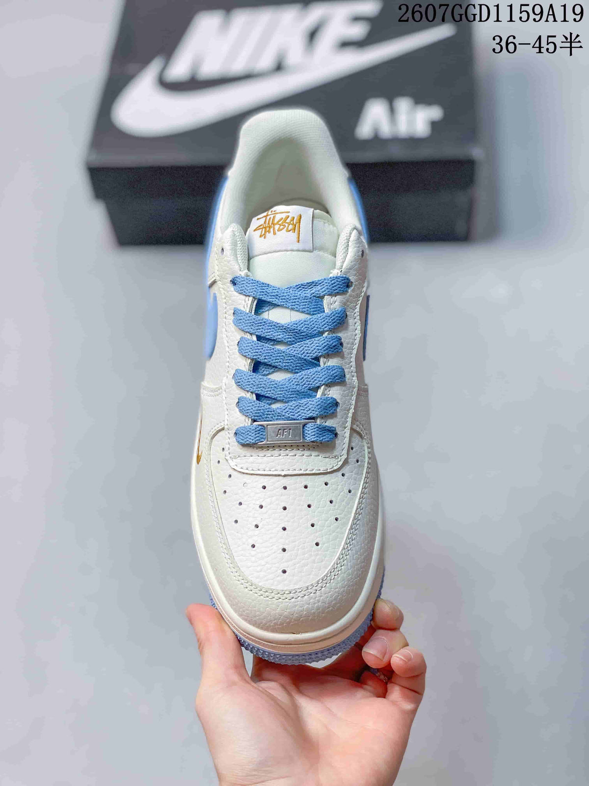 Top view showing the white perforated toe box, light blue laces and tongue branding.