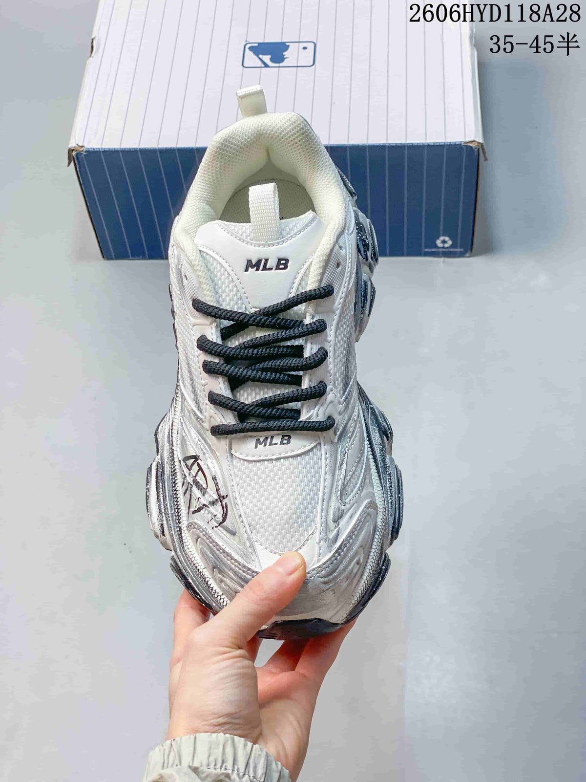 Top view of the sneaker with dark laces and MLB tongue lettering