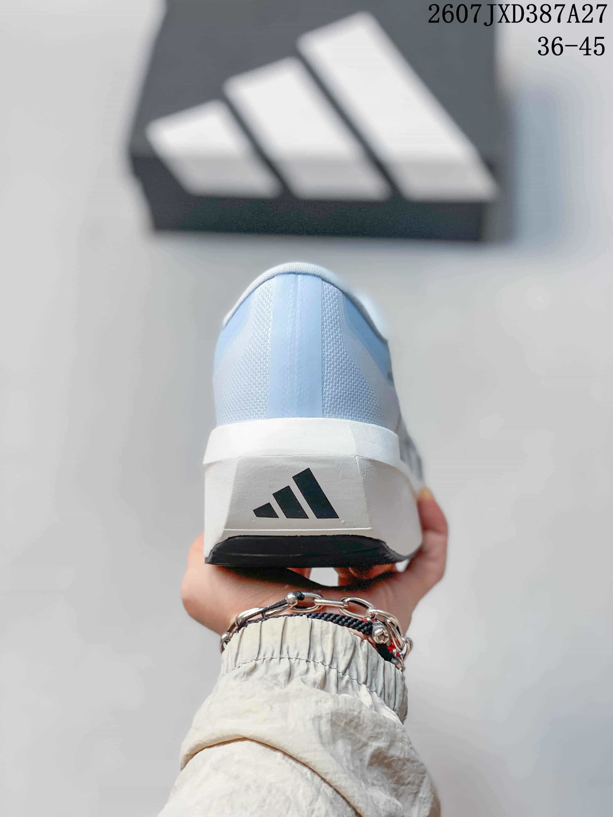 Rear view of the light blue shoe showing the white heel section, adidas logo, and black outsole edge.