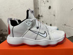 Side view of a white Nike sneaker with a black-outlined Swoosh and printed strap.