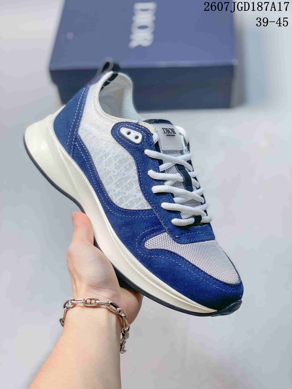 Blue and white Dior B25 Runner sneaker with white laces, mesh panels, and a light outsole.