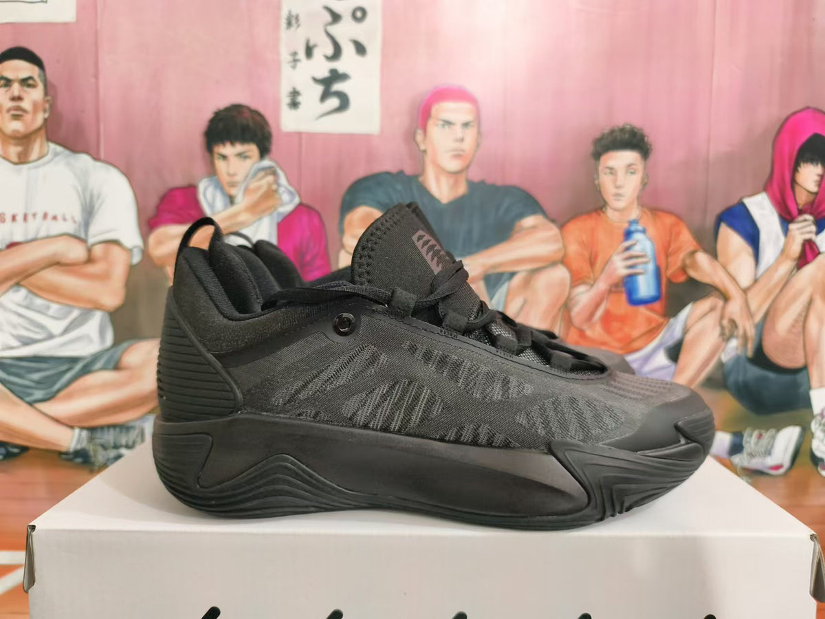 Side profile of an all-black Nike basketball shoe showing its patterned upper and sculpted outsole