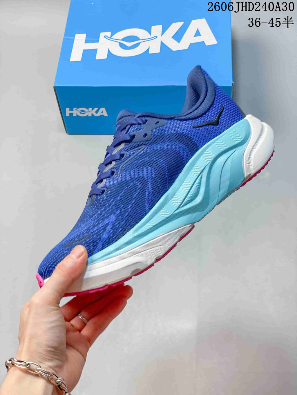Side view of a blue low-top running shoe with aqua midsole accents