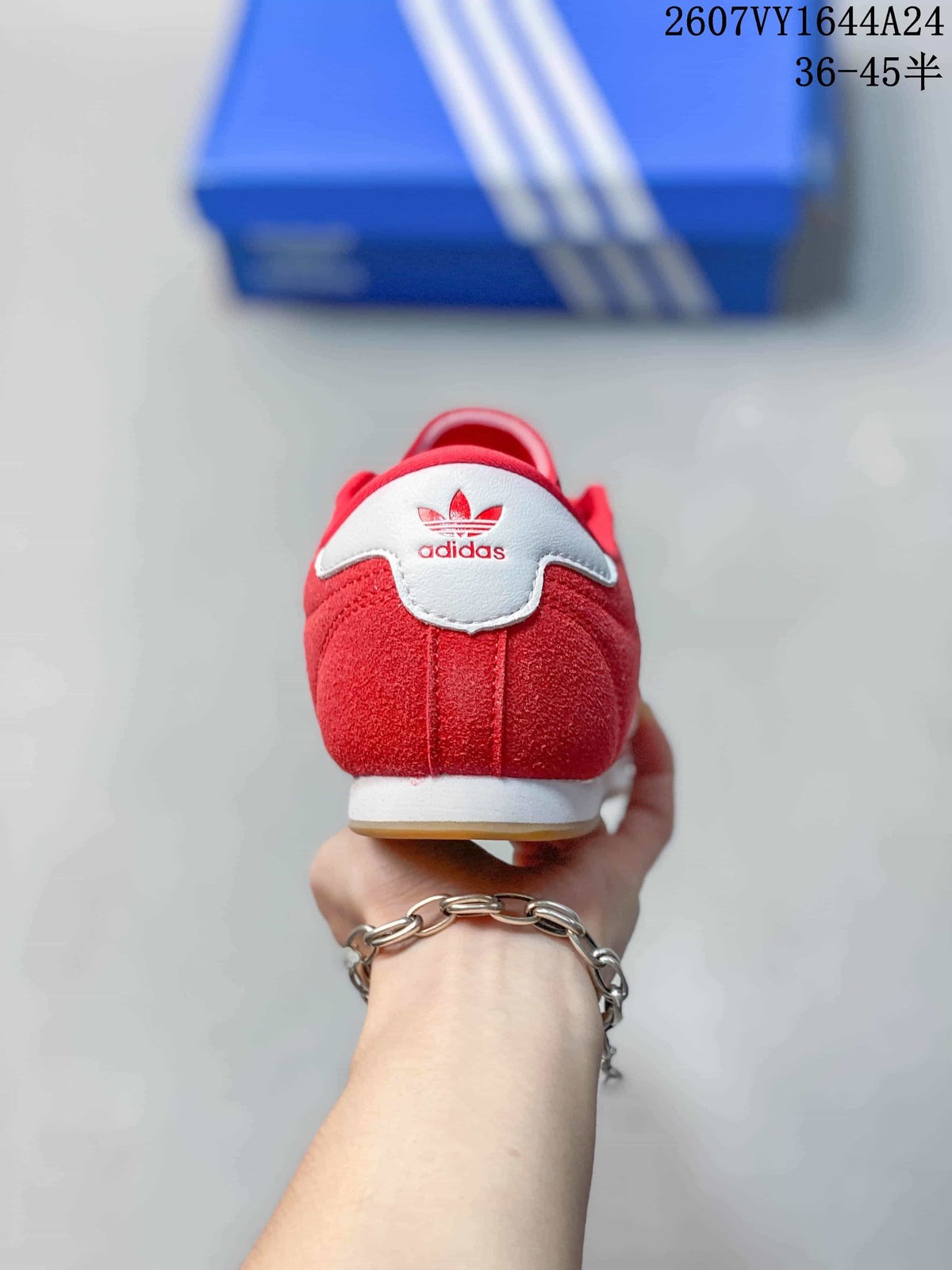 Rear view of the red adidas sneaker with a white heel detail and adidas branding.