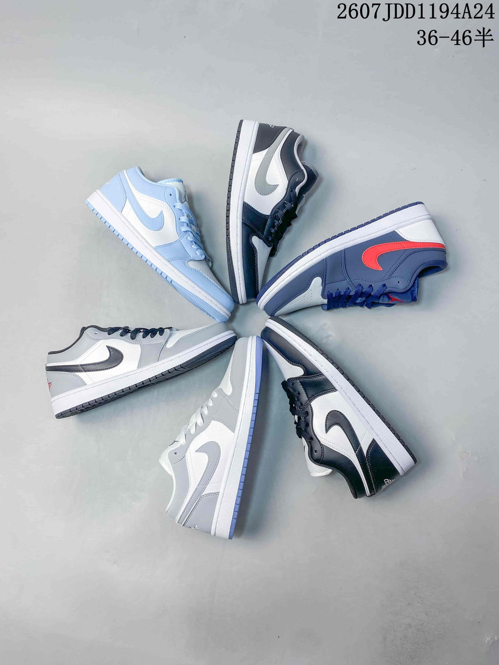 Several low-top Jordan sneakers arranged in a circular display, showing black-and-white, light blue-and-white, grey-and-white, and navy-and-red colorways.