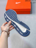 Close-up of the navy patterned outsole and white midsole of the sneaker.