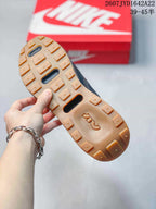 Close-up of the gum-colored outsole showing segmented tread blocks and elongated openings.