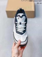 Top view of the sneaker showing white laces, a navy lace panel, gray toe detailing, and the ECCO logo mark.