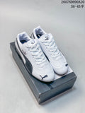 Pair of white and black Puma Speedcat OG sneakers displayed on a shoe box