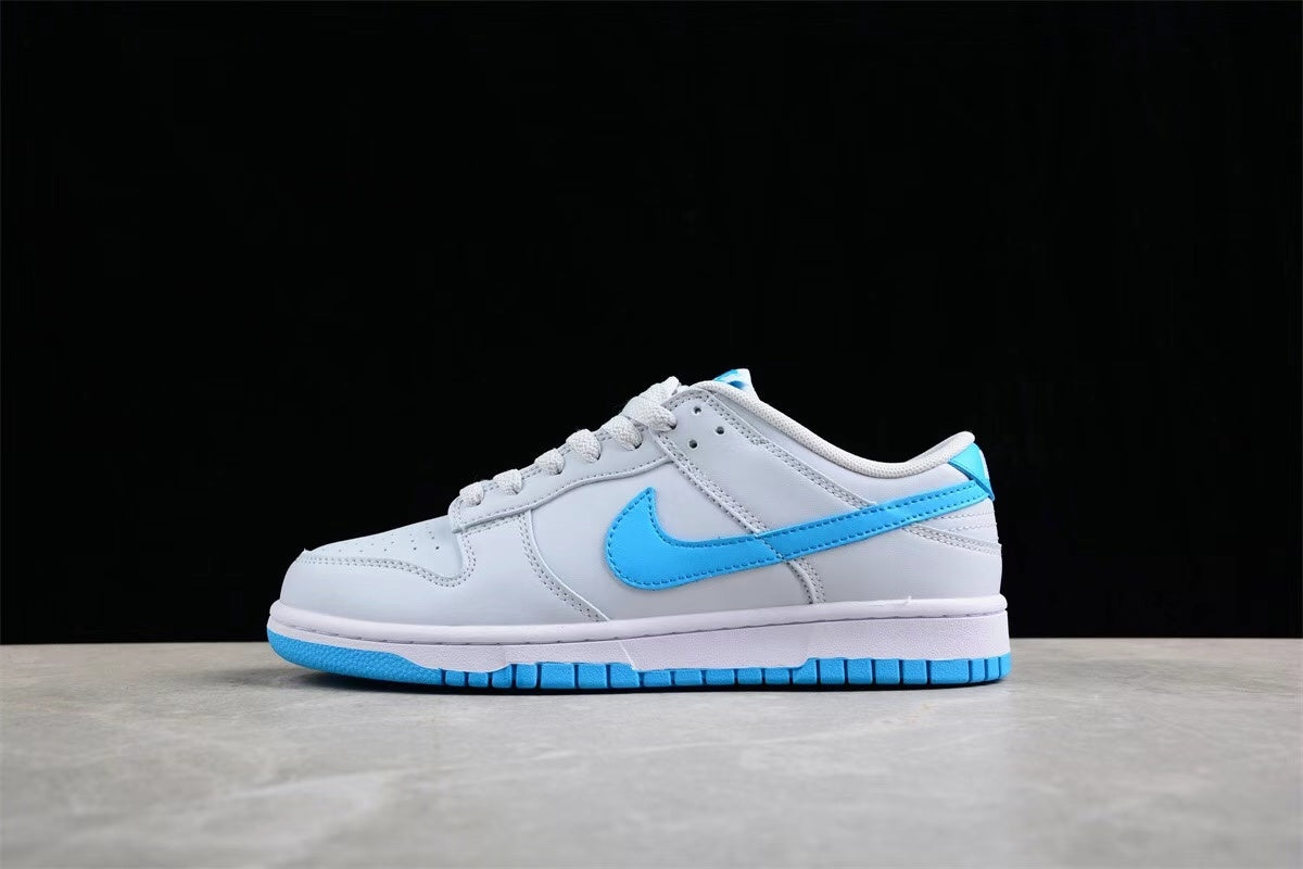Opposite side profile of the sneaker showing the light gray and white upper, bright blue Swoosh, white midsole, and blue outsole.