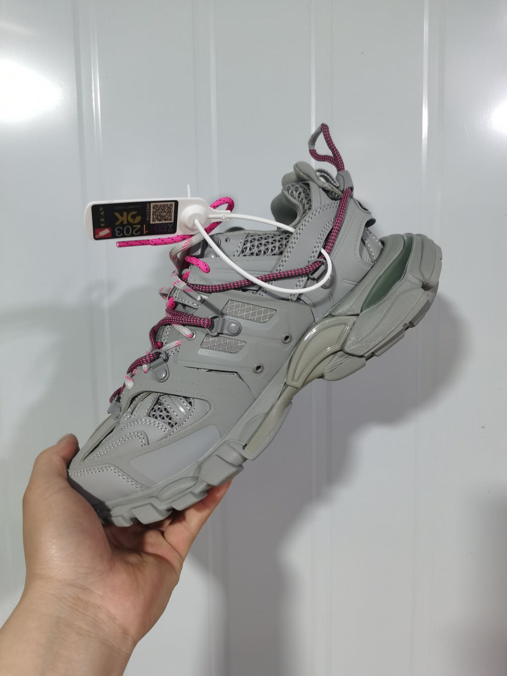 Rear-side view highlighting the layered heel structure, outsole and contrasting pink trim.