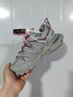 Rear-side view highlighting the layered heel structure, outsole and contrasting pink trim.