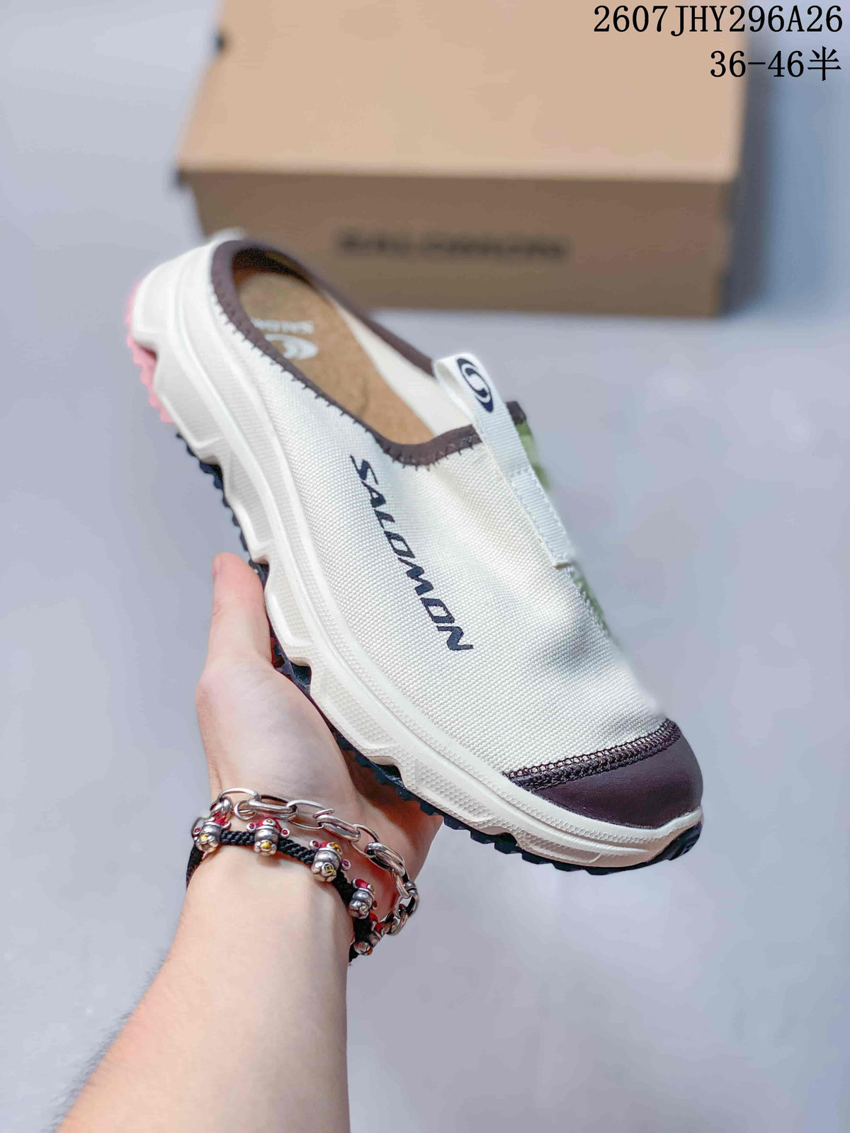 Angled side view of the Salomon RX Slide 3.0 slip-on showing the white upper, dark toe reinforcement and lug-style outsole.