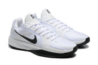 Side view of white basketball shoes with black Swooshes and white laces