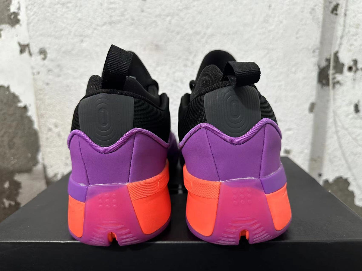 Rear view of purple, black and coral adidas Dame 9 shoes