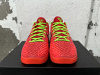 Front view of red textured Nike basketball sneakers with neon green laces