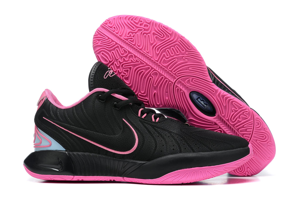 Black Nike basketball shoes with pink accents and bright pink outsoles.