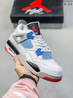 Close-up of a white high-top sneaker with blue eyelets and blue side mesh, plus grey and red outsole details.