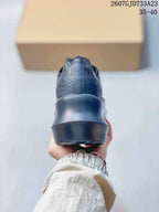 Rear view showing the textured heel panels and raised sculpted sole.