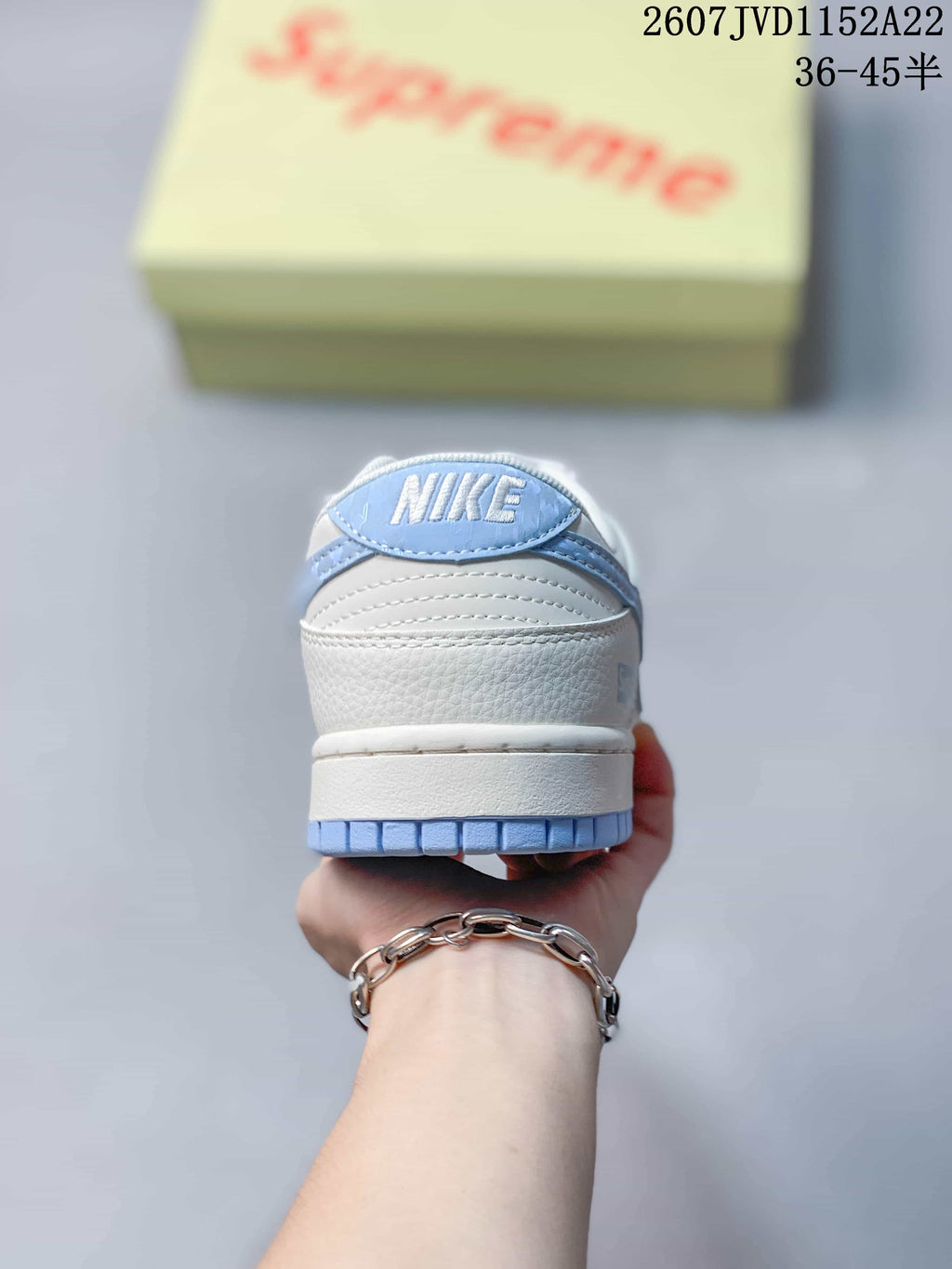 Rear view of the sneaker showing the white heel and light blue outsole edge.