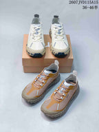 White and tan NORDA sneakers arranged together, showing both colorways and their contrasting outsole designs.