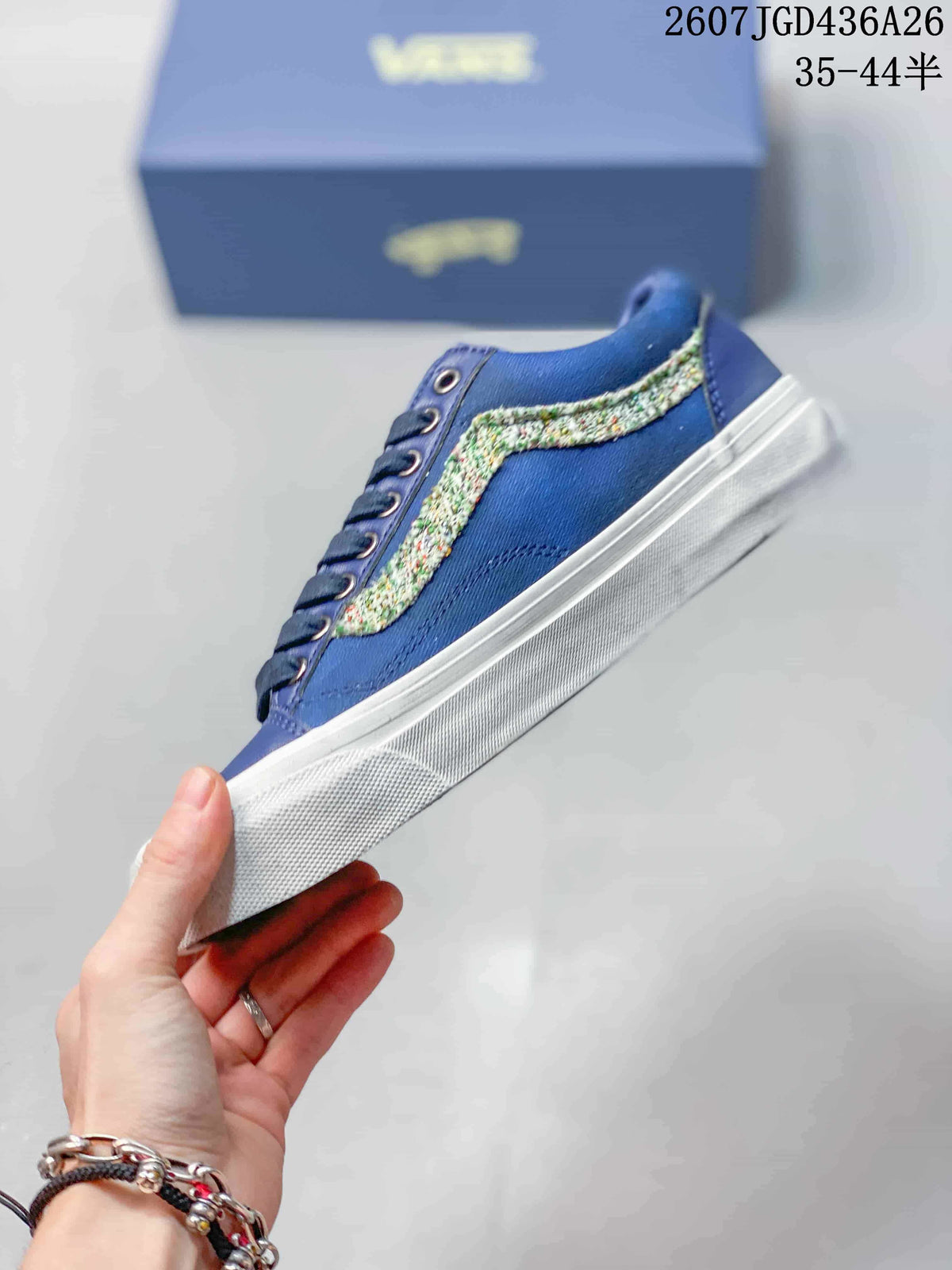 Side view of the blue low-top sneaker with a multicolor textured stripe and white rubber sole.