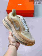 Cream and tan Nike Air Zoom Pegasus Premium sneaker with a metallic silver side Swoosh.